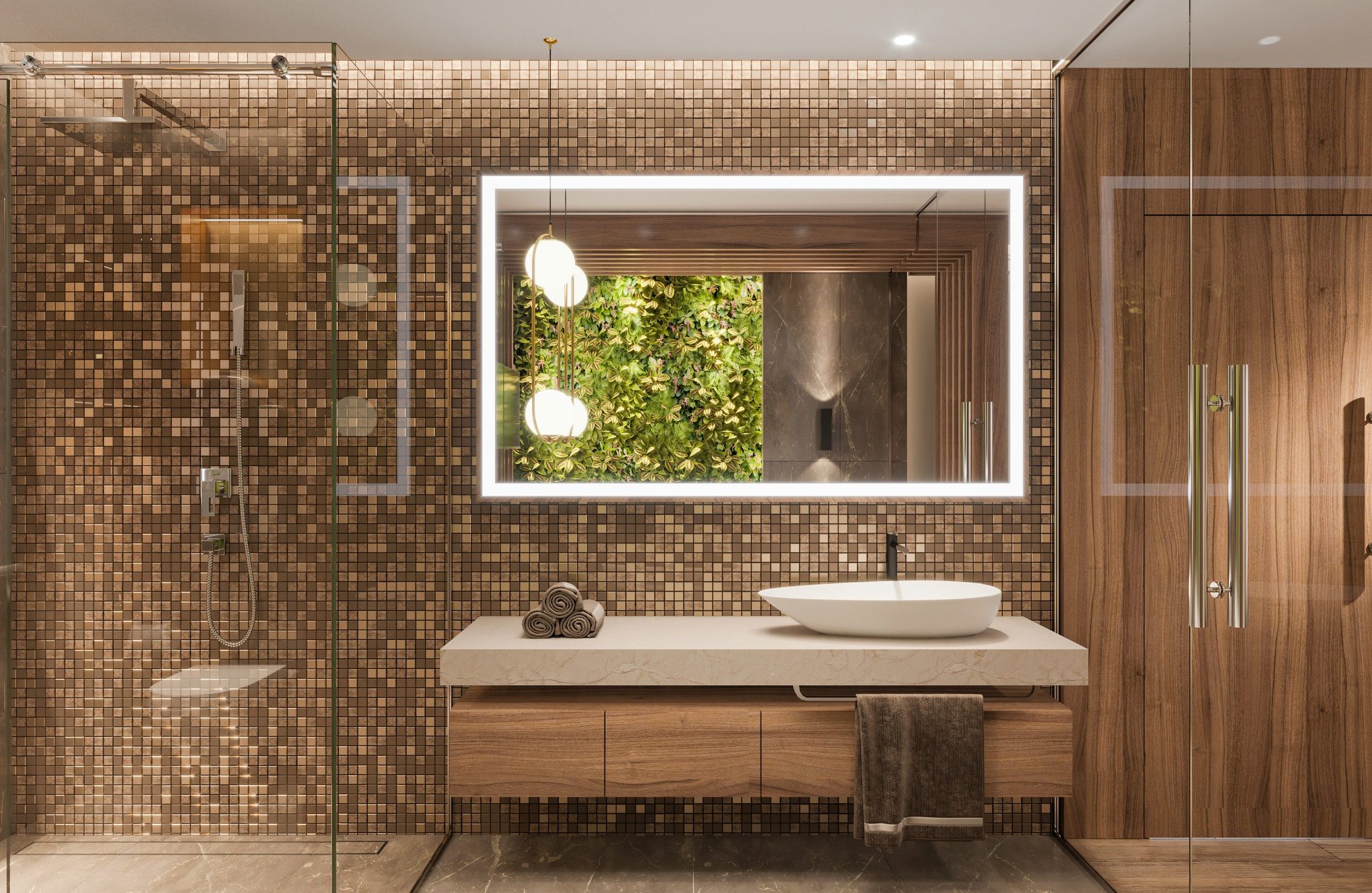 A modern bathroom with a wooden vanity, white vessel sink, and large illuminated mirror. The wall behind the vanity features mosaic tiles. To the left is a glass-enclosed shower, and the floor is made of marble. Towels are neatly rolled on the countertop.